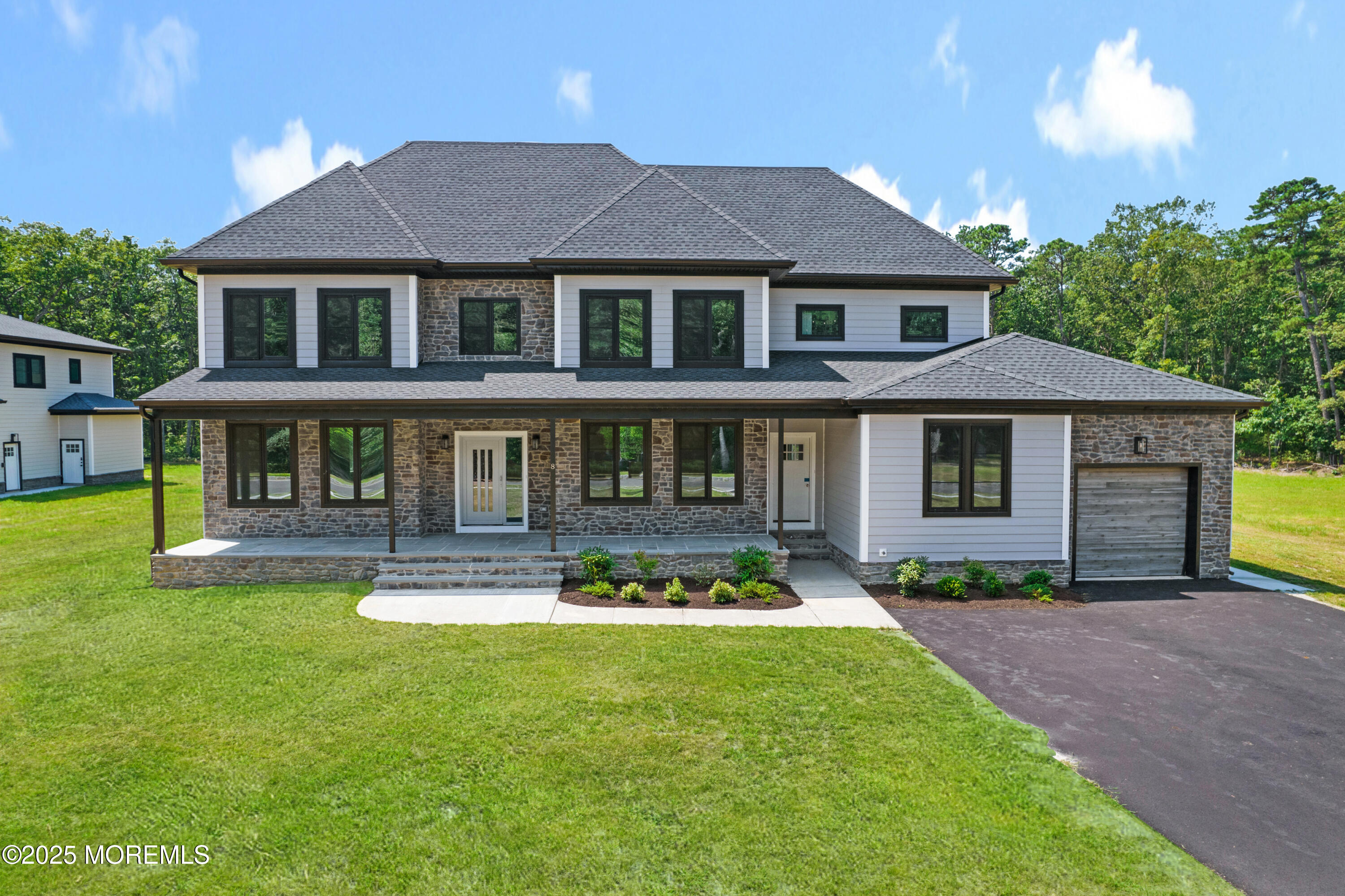 8 Haystack Court Howell, NJ 07731 - Photo 2 of 40 a front view of a house with a yard table and chairs