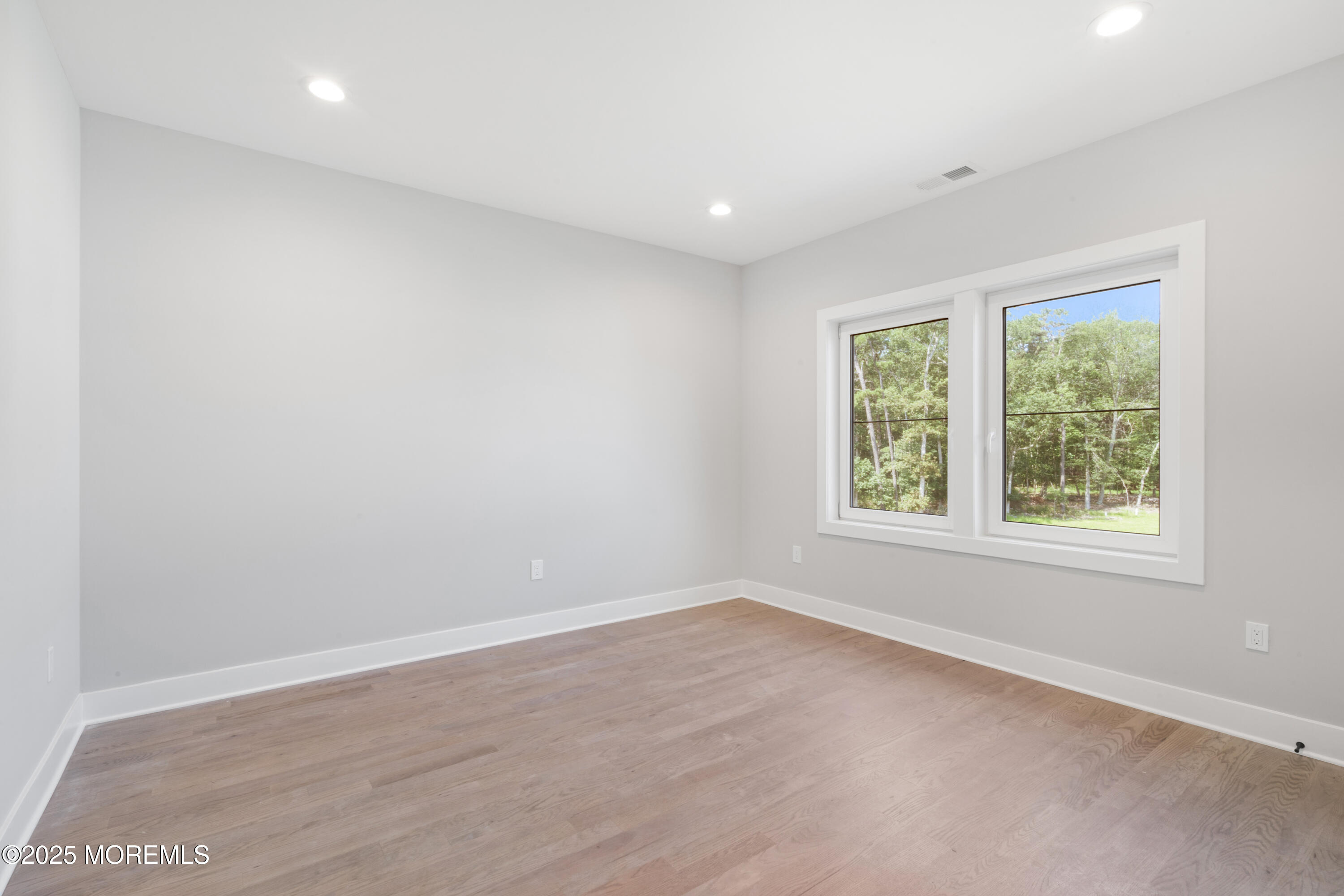 8 Haystack Court Howell, NJ 07731 - Photo 21 of 40 an empty room with wooden floor and windows