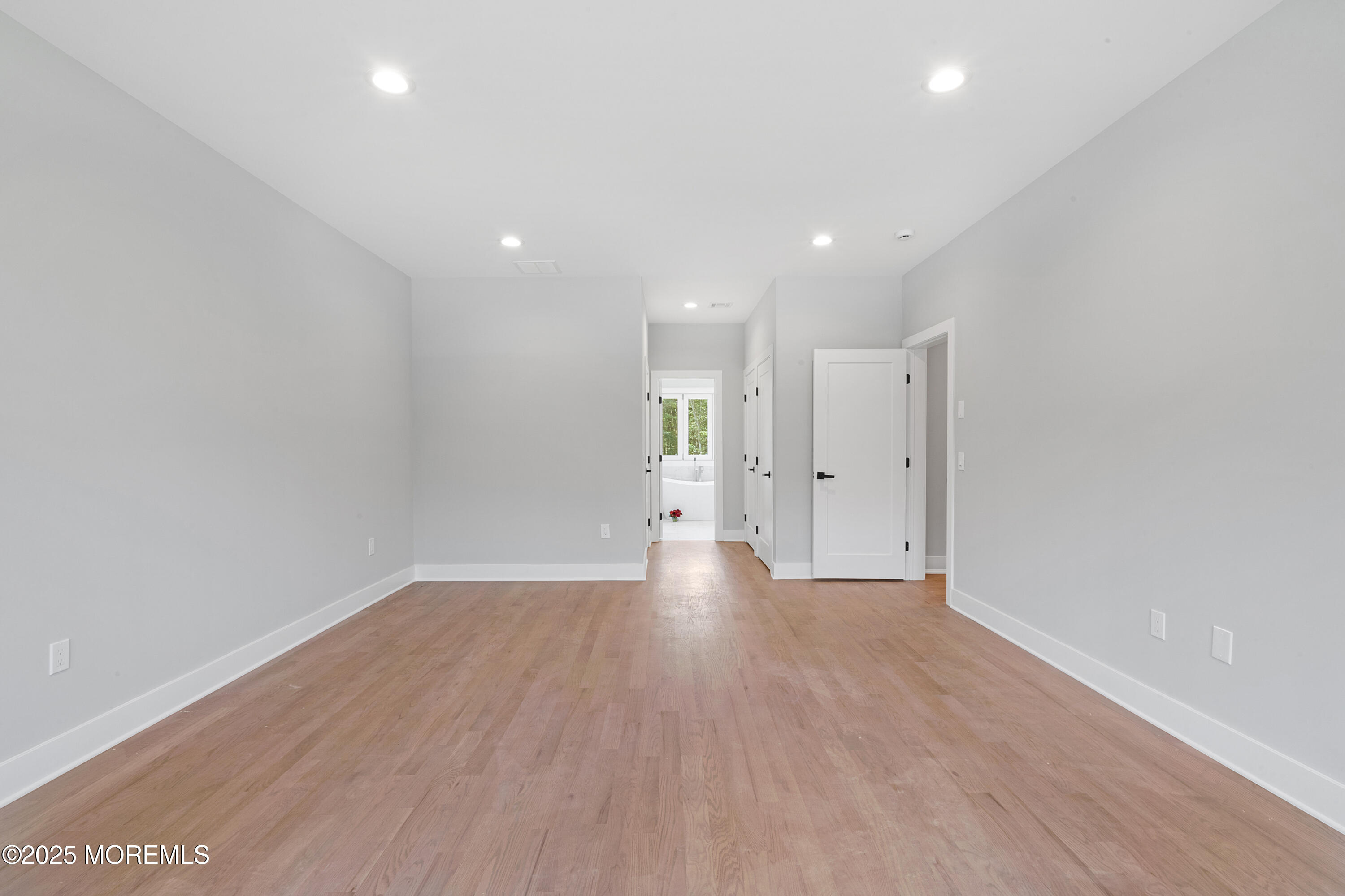 8 Haystack Court Howell, NJ 07731 - Photo 28 of 40 a view of a big room with wooden floor and windows