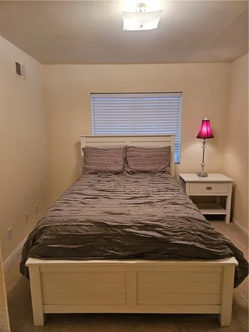 a bedroom with a bed and a cabinets