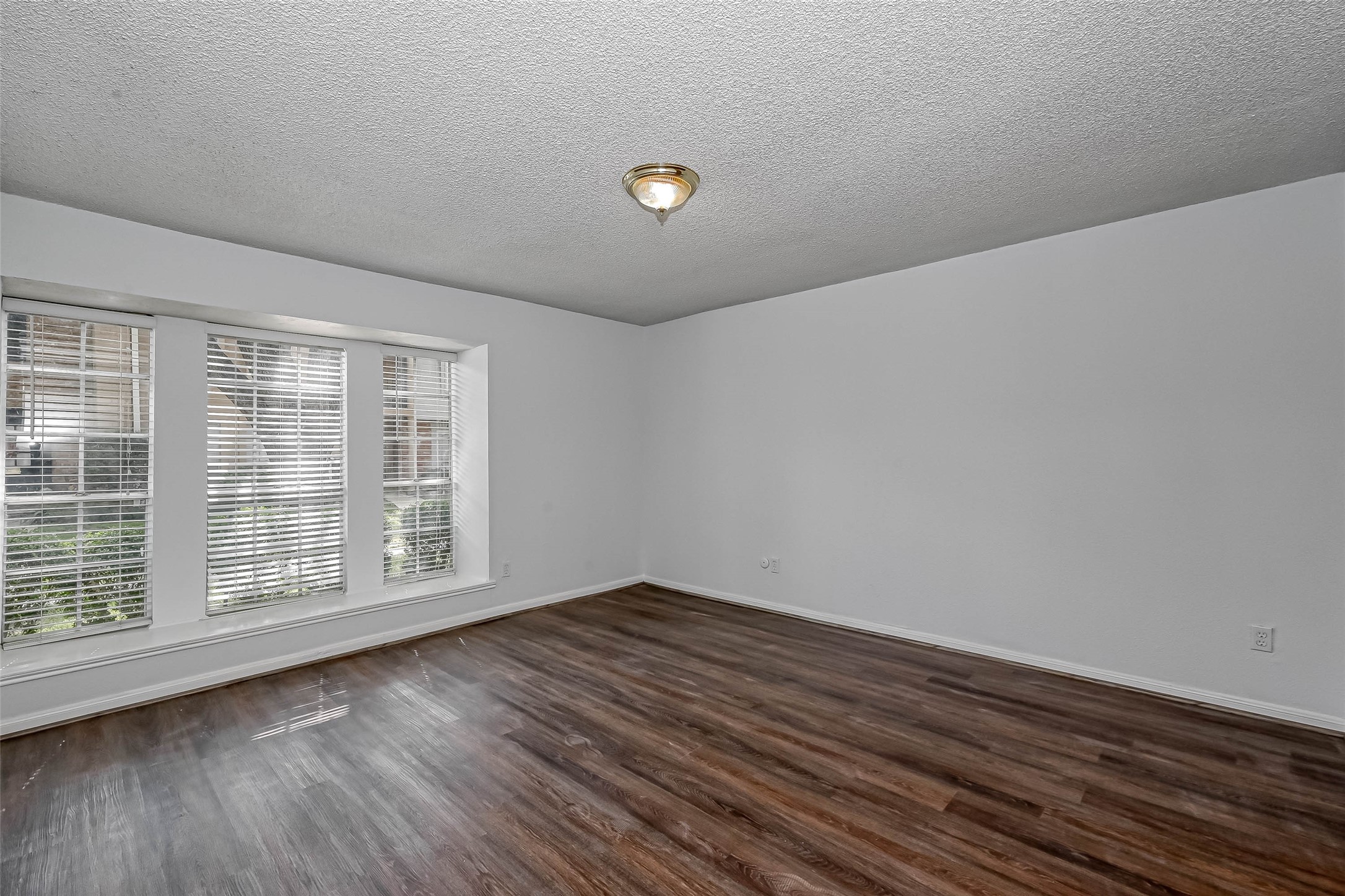 14179 Misty Meadow Lane Houston, TX 77079 - Photo 24 of 41 wooden floor in an empty room with a window
