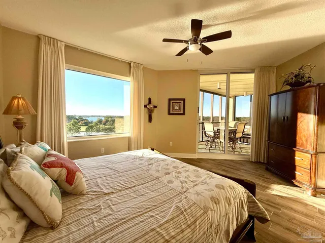 a bedroom with a bed a window and a flat screen tv