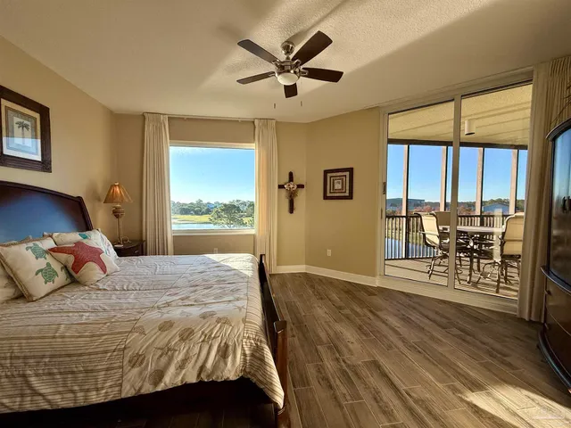 a bedroom with a balcony a bed and a table