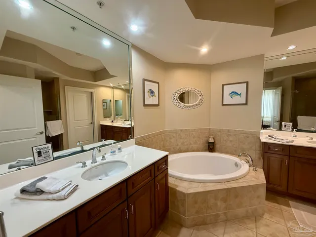a bathroom with a granite countertop sink toilet and mirror