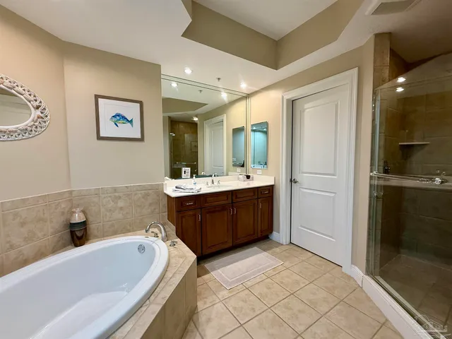 a bathroom with a tub sink and mirror
