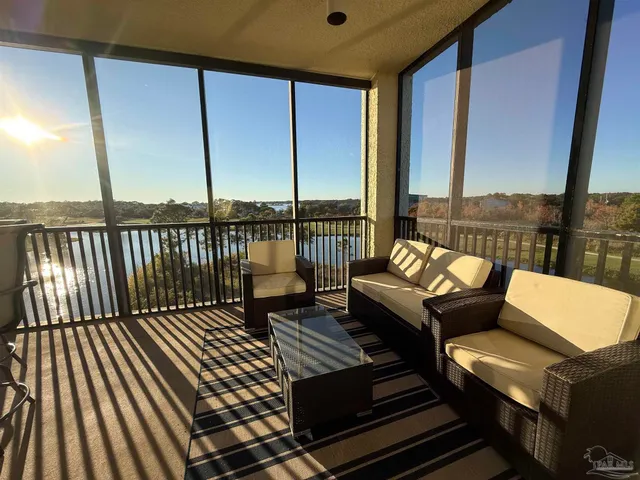 a roof deck with couches and wooden floor