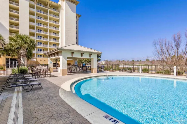 a swimming pool with outdoor seating and yard