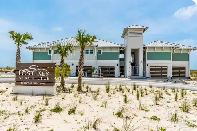 a front view of a building with street sign