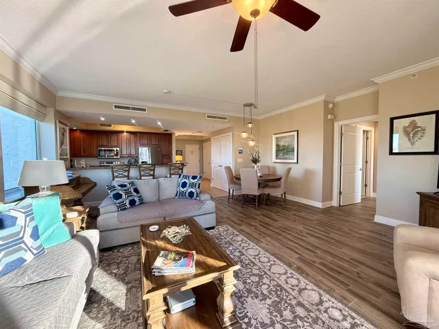 a living room with furniture or couch and a ceiling fan