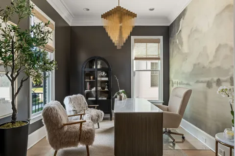 a living room with furniture and a potted plant