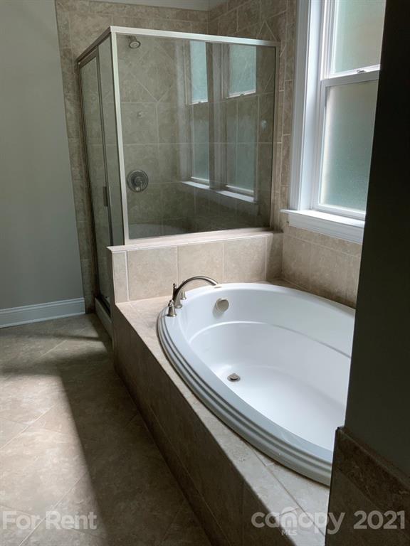 3028 Fallondale Road, Unit 894 Waxhaw, NC 28173 - Photo 12 of 27 a bathroom with a bathtub and a shower
