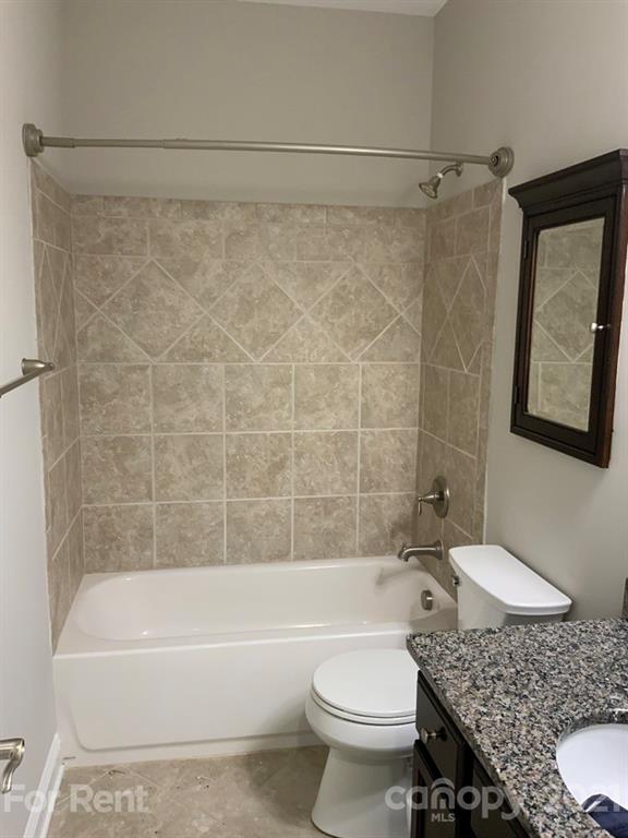 3028 Fallondale Road, Unit 894 Waxhaw, NC 28173 - Photo 17 of 27 a bathroom with a granite countertop bathtub shower sink vanity and toilet