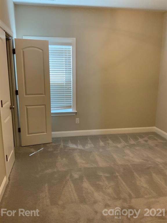 3028 Fallondale Road, Unit 894 Waxhaw, NC 28173 - Photo 19 of 27 a view of an empty room with a window