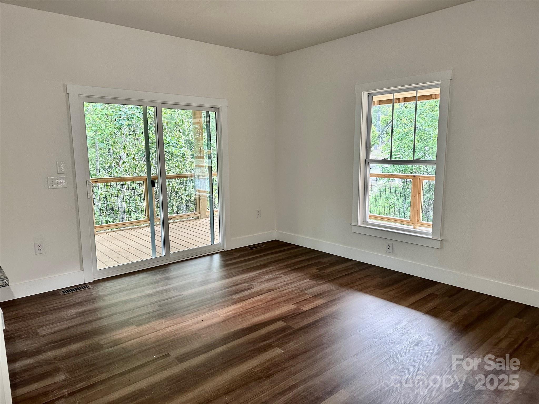 206 Cascade Rdg Road Fairview, NC 28730 - Photo 13 of 38 a view of an empty room with wooden floor and a window