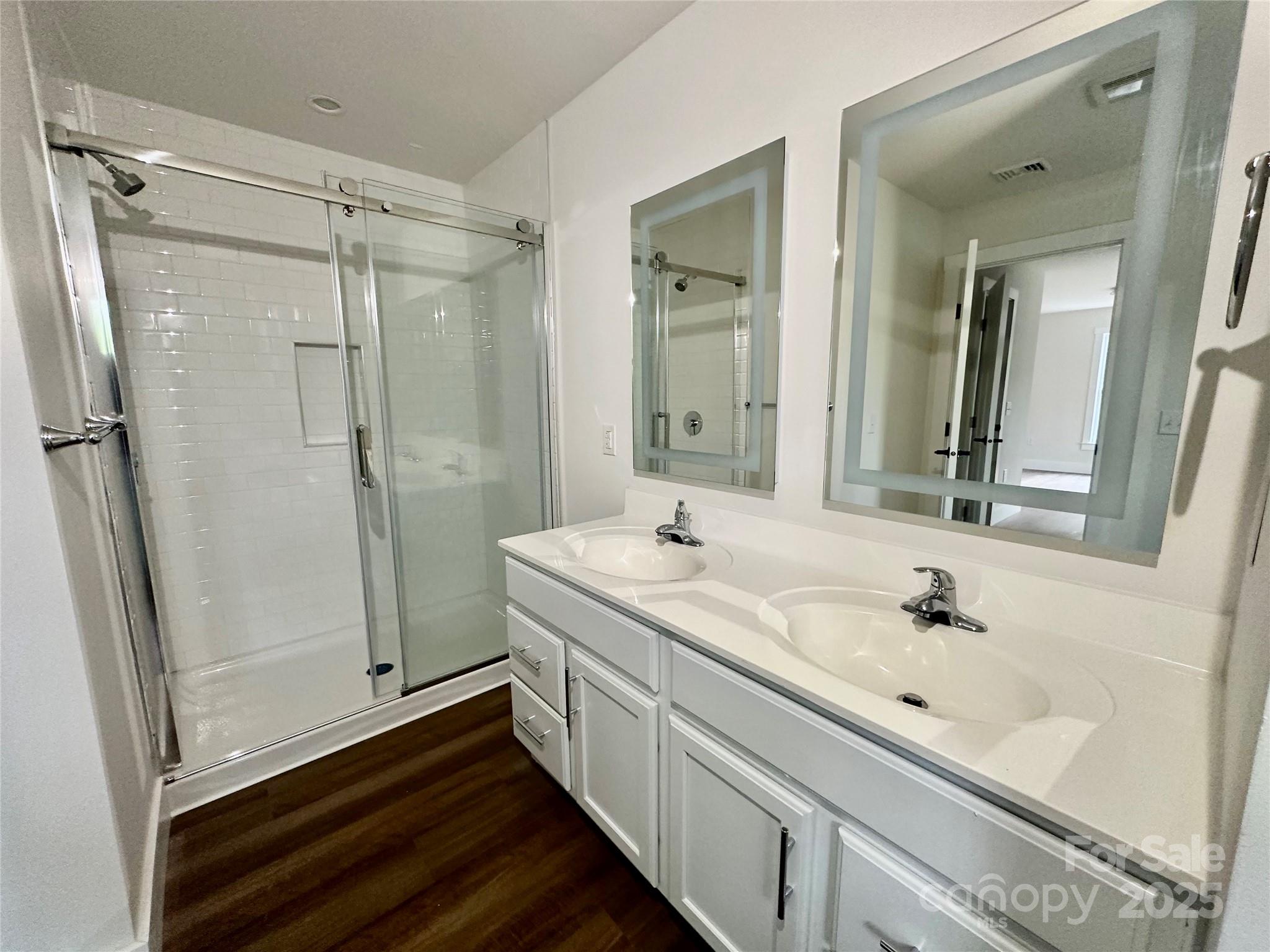 206 Cascade Rdg Road Fairview, NC 28730 - Photo 17 of 38 a bathroom with a double vanity sink a toilet and a mirror