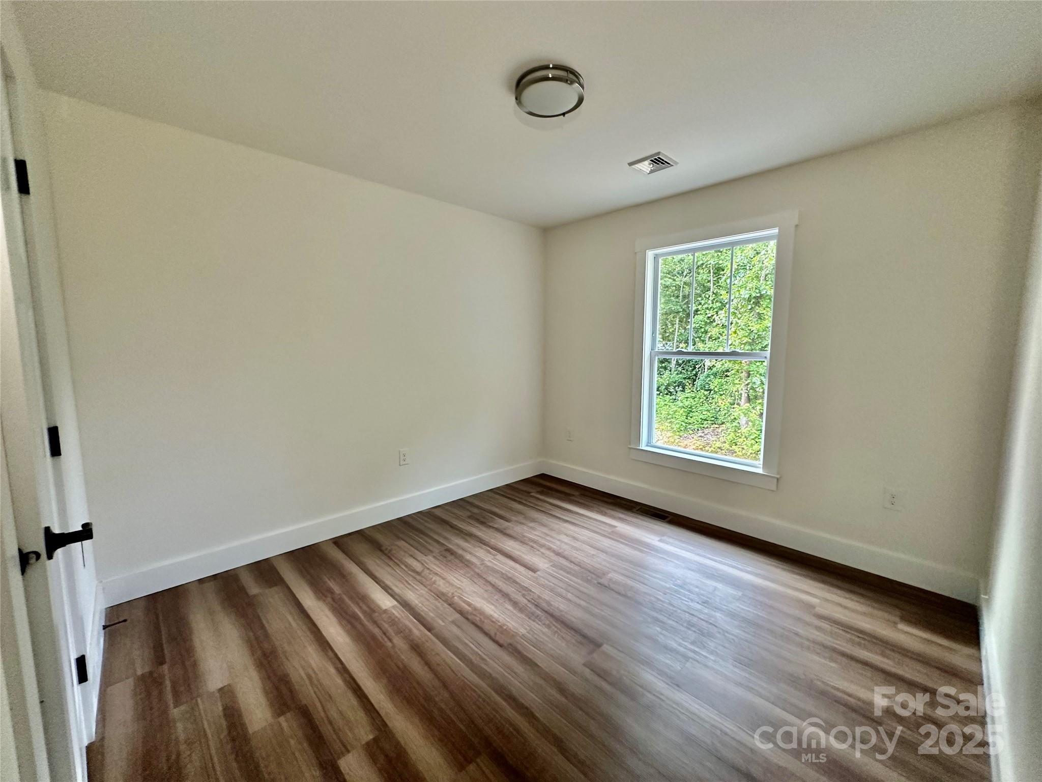 206 Cascade Rdg Road Fairview, NC 28730 - Photo 18 of 38 an empty room with wooden floor and windows