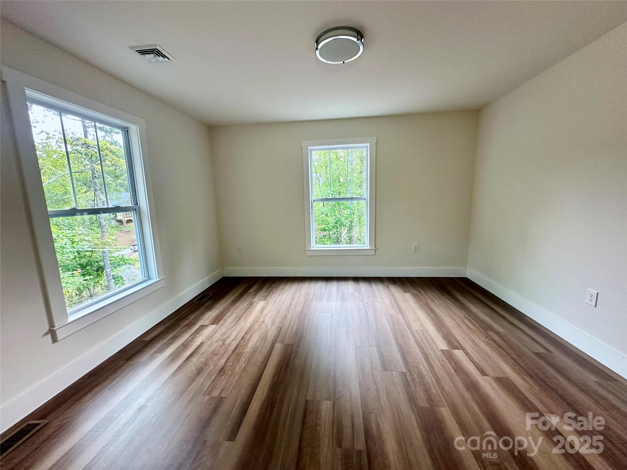 206 Cascade Rdg Road Fairview, NC 28730 - Photo 22 of 38 an empty room with wooden floor and windows