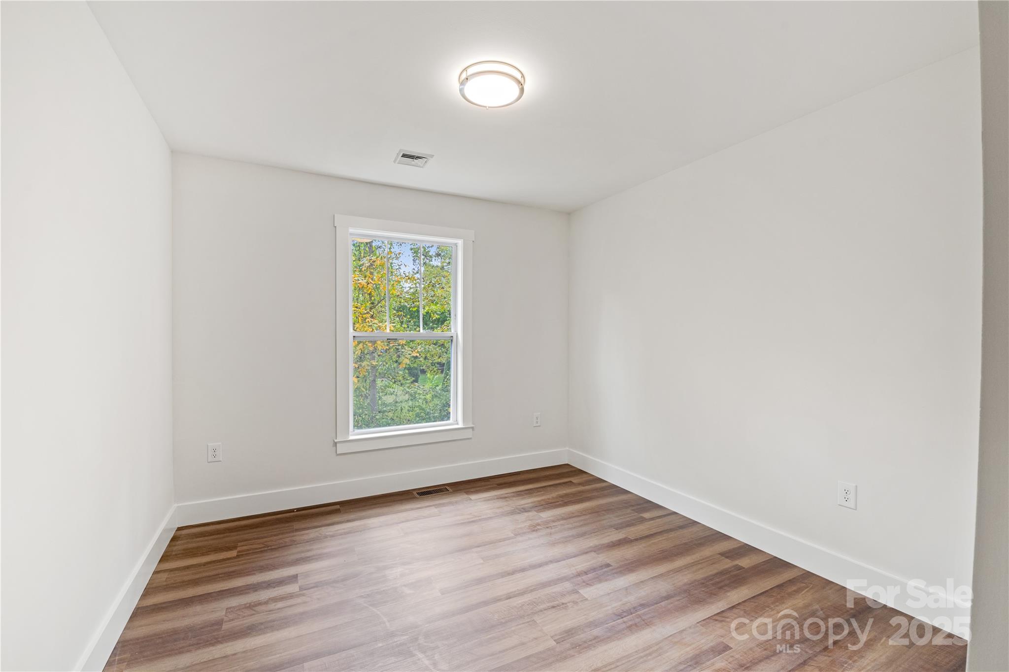 206 Cascade Rdg Road Fairview, NC 28730 - Photo 29 of 38 an empty room with wooden floor and windows