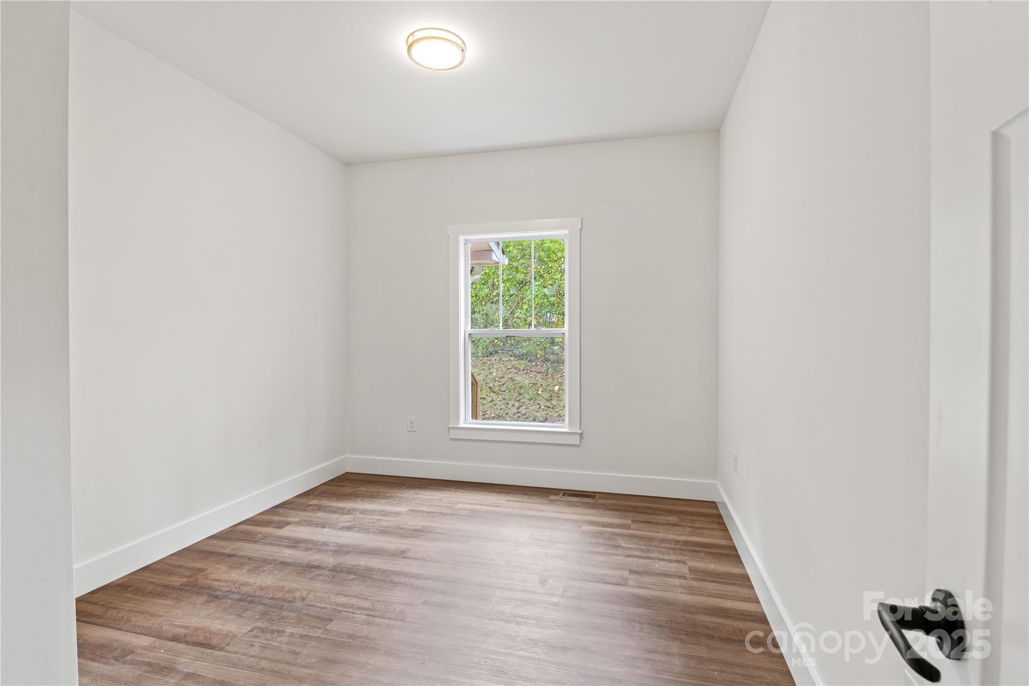 206 Cascade Rdg Road Fairview, NC 28730 - Photo 30 of 38 an empty room with wooden floor and windows