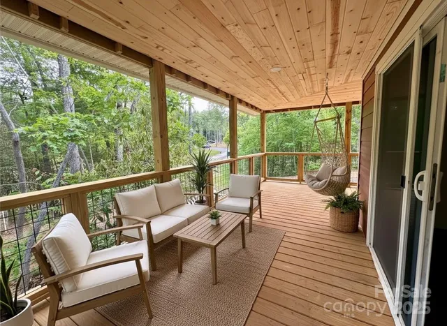 a balcony with wooden floor and outdoor seating