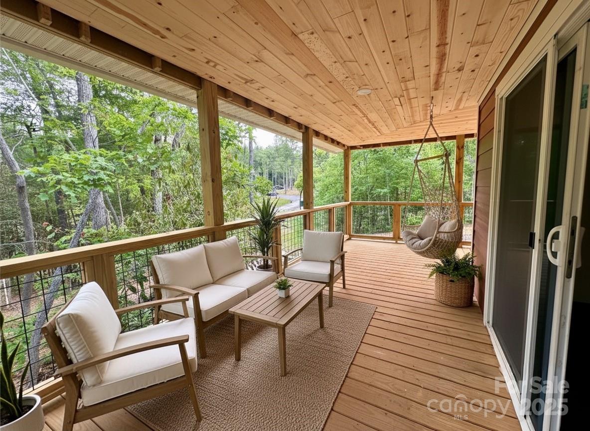 206 Cascade Rdg Road Fairview, NC 28730 - Photo 3 of 38 a balcony with wooden floor and outdoor seating