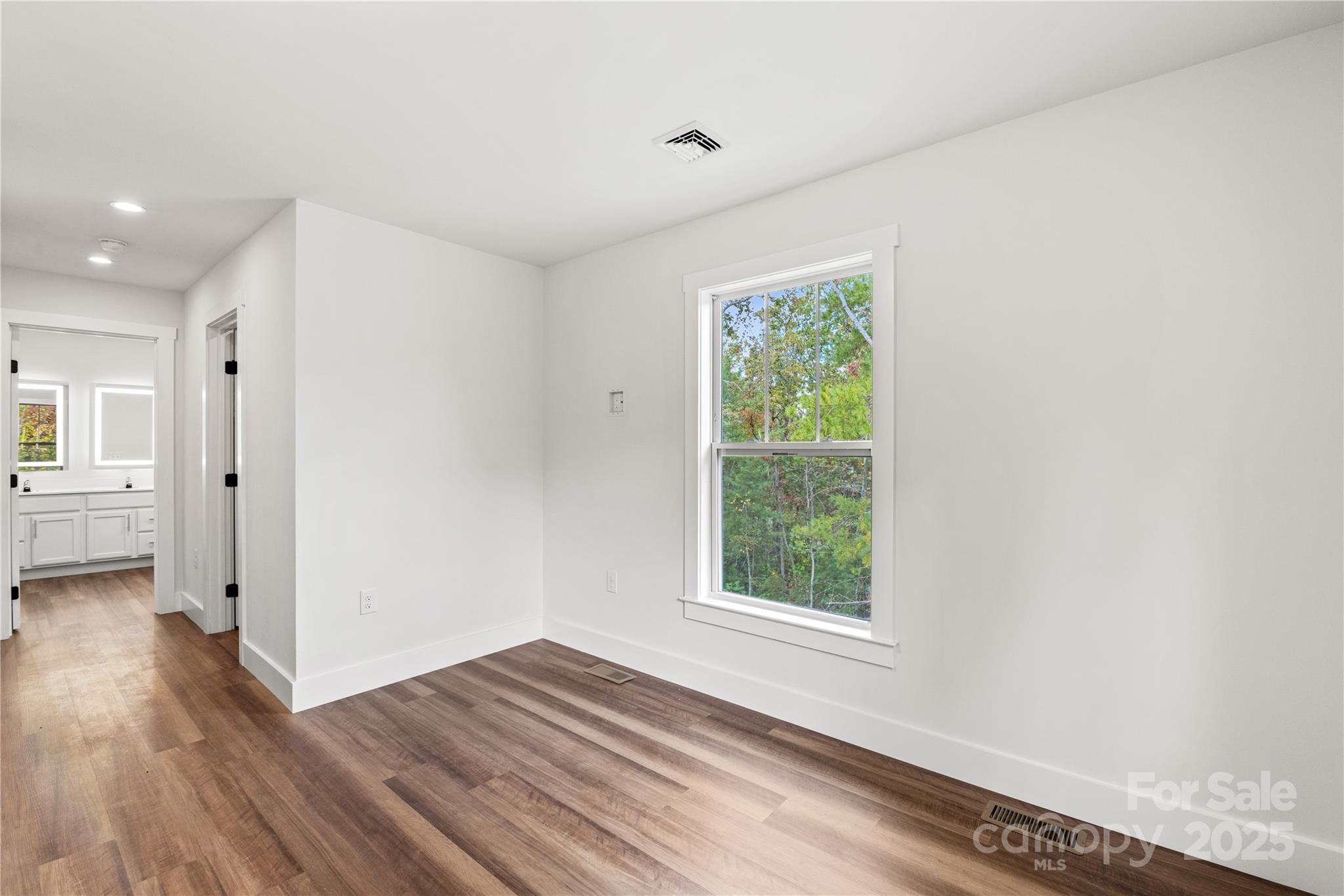 206 Cascade Rdg Road Fairview, NC 28730 - Photo 32 of 38 a view of an empty room with wooden floor and a window