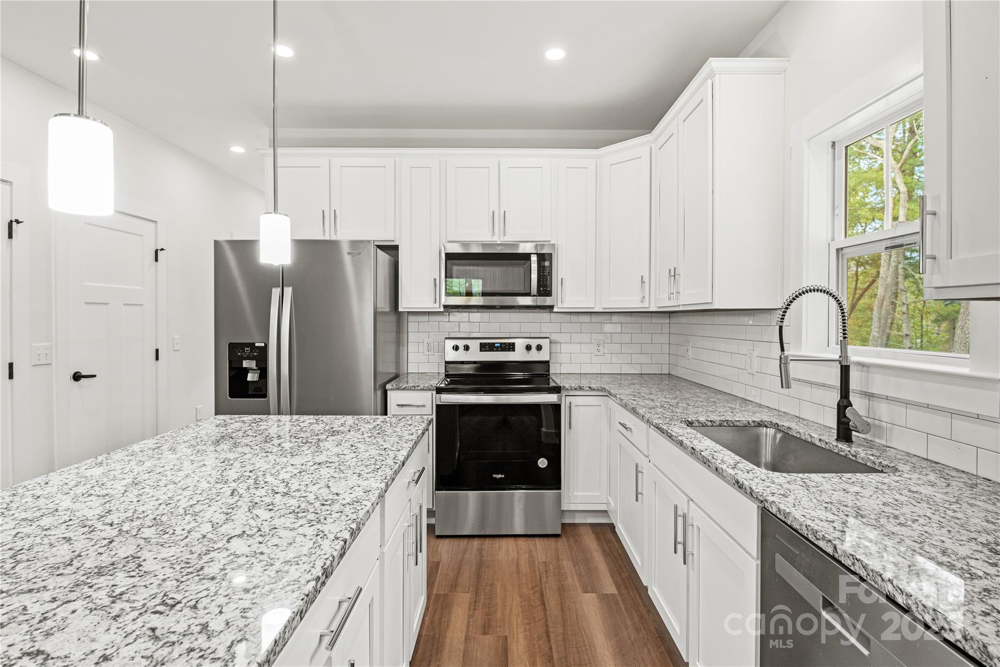 206 Cascade Rdg Road Fairview, NC 28730 - Photo 9 of 38 a kitchen with stainless steel appliances granite countertop a stove refrigerator sink and microwave