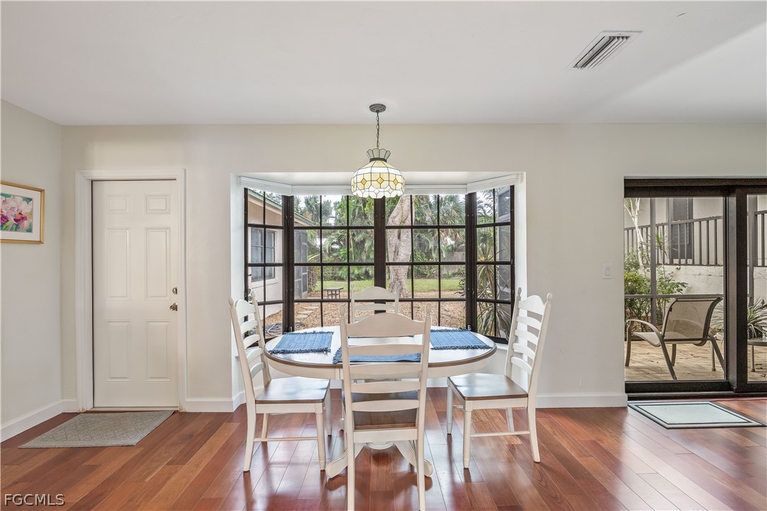 3209 West Riverside Drive Fort Myers, FL 33901 - Photo 11 of 31 a view of a dining room with furniture window and wooden floor