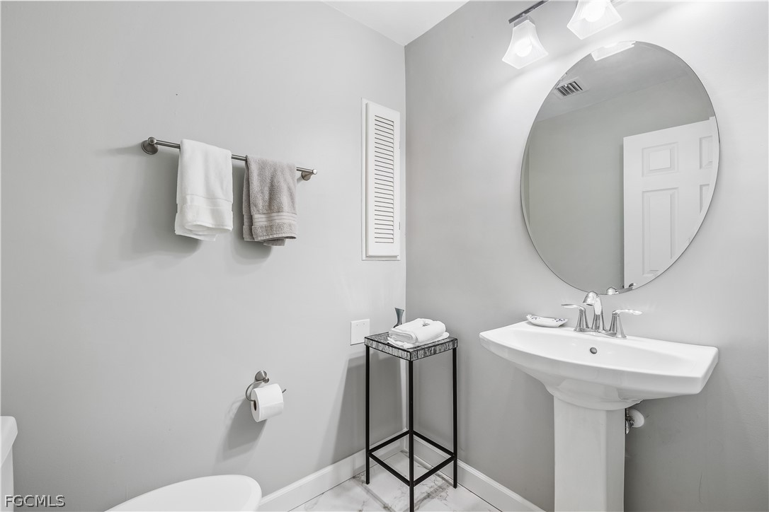 3209 West Riverside Drive Fort Myers, FL 33901 - Photo 16 of 31 a bathroom with a sink and mirror