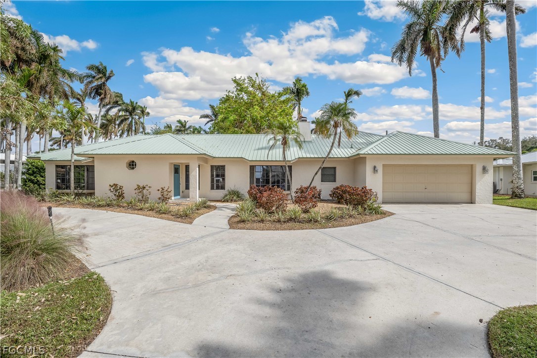 3209 West Riverside Drive Fort Myers, FL 33901 - Photo 2 of 31 front view of a house with a patio