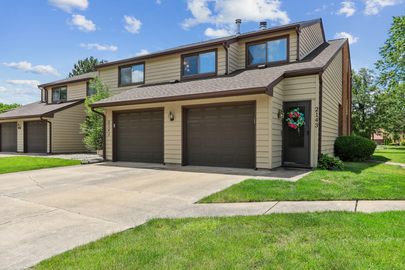 2143 Harbor Town Circle Champaign, IL 61821 - Photo 2 of 29 a front view of a house with a yard and garage