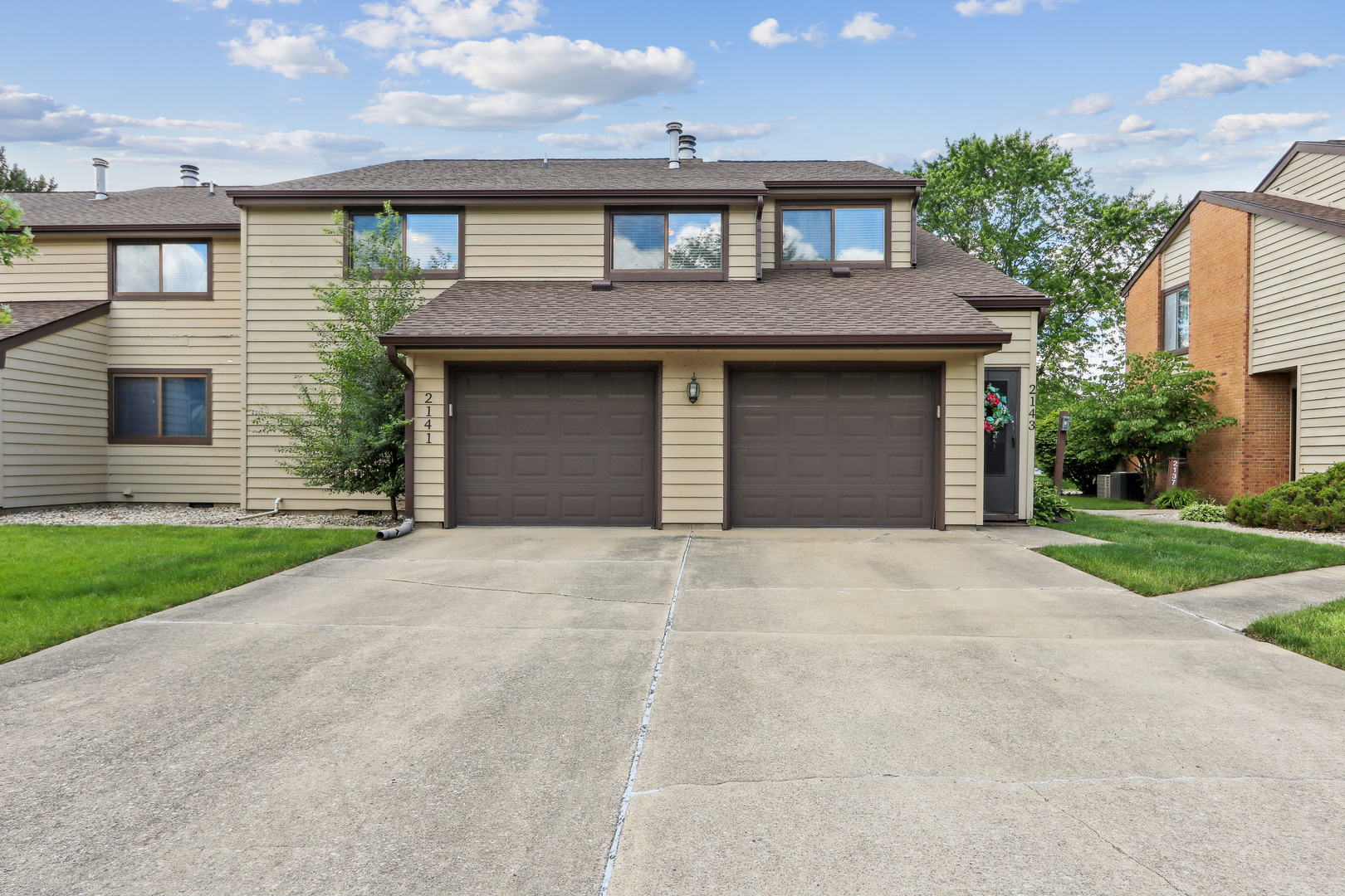 2143 Harbor Town Circle Champaign, IL 61821 - Photo 3 of 29 a front view of a house with a yard and garage