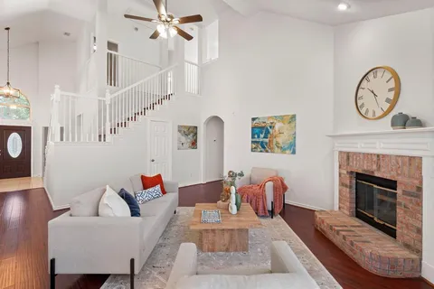 a living room with furniture a clock and a fireplace