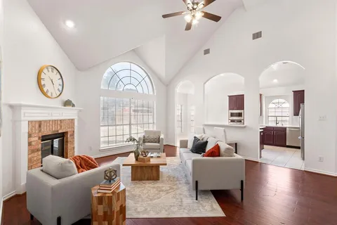 a living room with furniture chandelier and fireplace