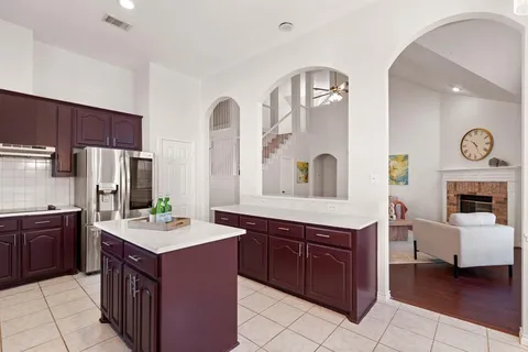 a large kitchen with a stove a sink dishwasher and a refrigerator