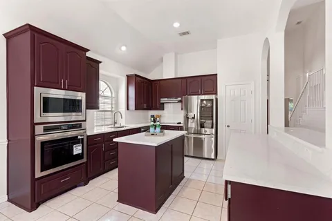 a kitchen with stainless steel appliances a stove a refrigerator a sink a oven and dishwasher