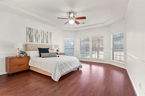 a bedroom with a large bed and a large window