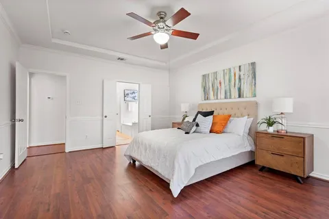 a bedroom with a bed and a chandelier
