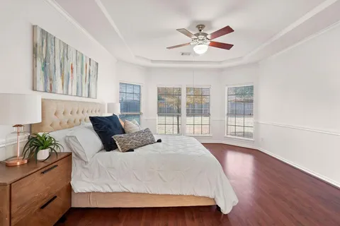 a bedroom with a large bed and a window