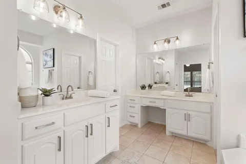 a bathroom with a sink vanity and mirror