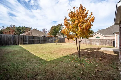 a view of backyard of house with green space