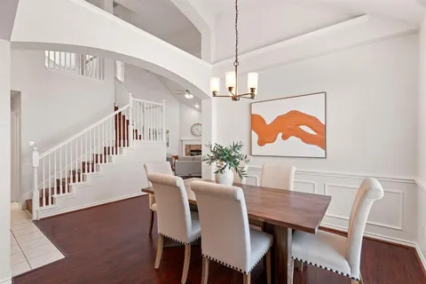 a view of a dining room and hall with wooden floor