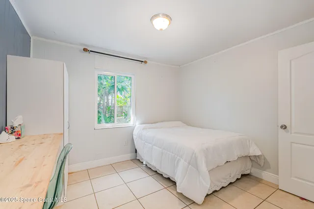 a bedroom with a bed and a window in it