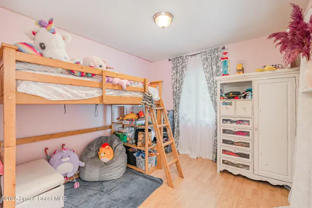 a view of room with toys and wooden floor