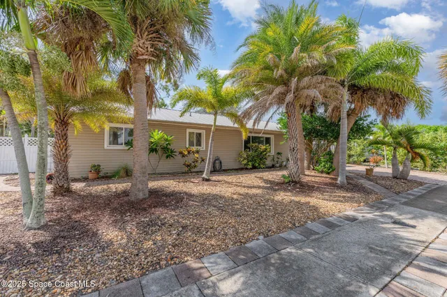 a view of a house with a tree in the background