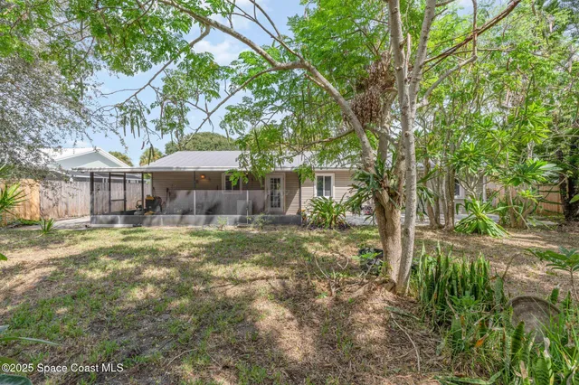 a backyard of a house with a yard and outdoor seating