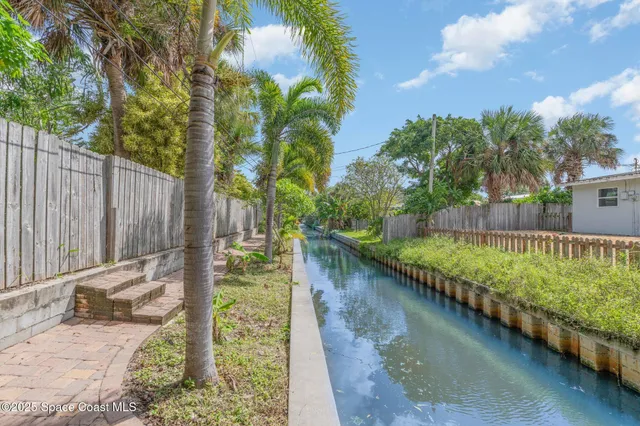 a view of a garden with wooden fence