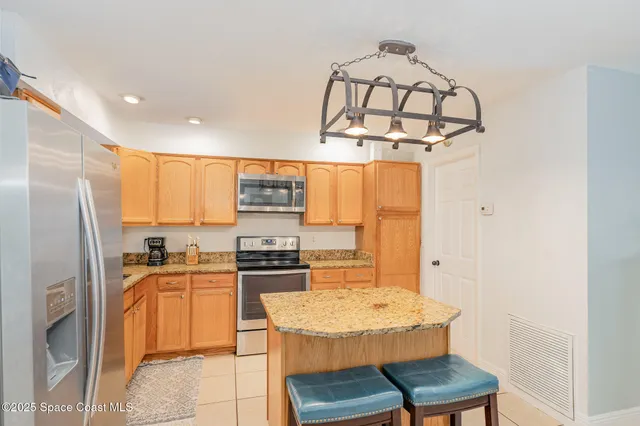 a kitchen with stainless steel appliances a sink stove and refrigerator