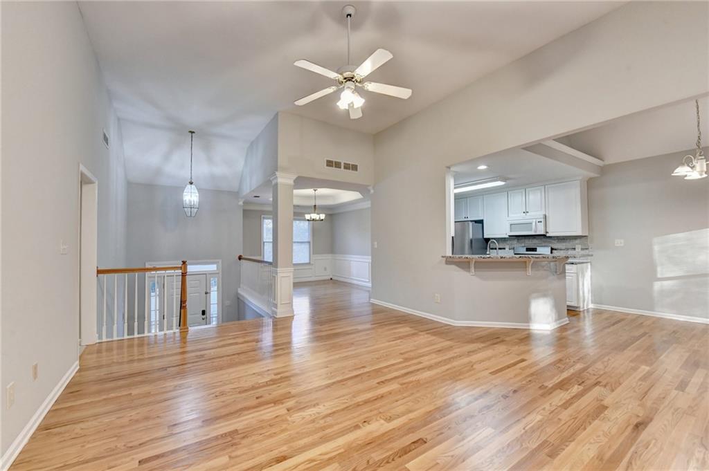 655 Golden Meadows Lane Suwanee, GA 30024 - Photo 15 of 72 a view of kitchen with cabinets and wooden floor