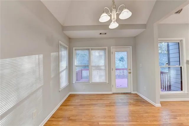 a view of kitchen and hall with wooden floor